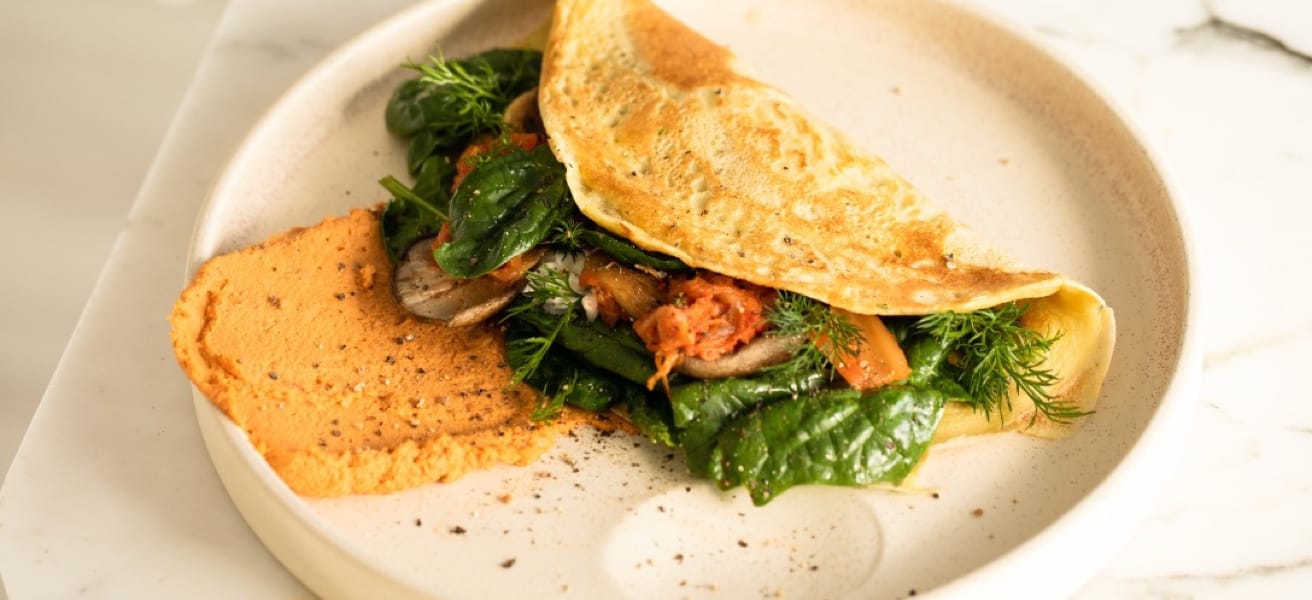 omelette with greens on a white plate